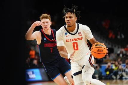 Mar 23, 2024; Omaha, NE, USA; Illinois Fighting Illini guard Terrence Shannon Jr. (0) dribbles the ball against Duquesne Dukes forward Jake Necas (7) during the second half in the second round of the 2024 NCAA Tournament at CHI Health Center Omaha. Mandatory Credit: Dylan Widger-USA TODAY Sports