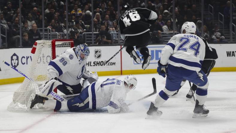 Mar 23, 2024; Los Angeles, California, USA; Los Angeles Kings center Blake Lizotte (46) leaps over Tampa Bay Lighting defensemen Erik Cernak (81) during the second period of an NHL hockey game at Crypto.com Arena. Mandatory Credit: Yannick Peterhans-USA TODAY Sports