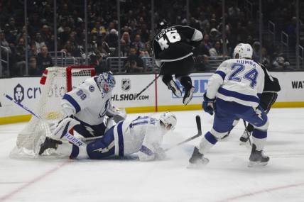 Mar 23, 2024; Los Angeles, California, USA; Los Angeles Kings center Blake Lizotte (46) leaps over Tampa Bay Lighting defensemen Erik Cernak (81) during the second period of an NHL hockey game at Crypto.com Arena. Mandatory Credit: Yannick Peterhans-USA TODAY Sports