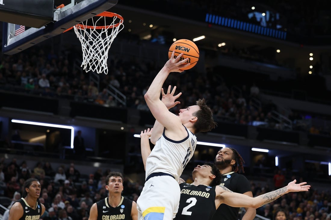 Mar 24, 2024; Indianapolis, IN, USA; Marquette Golden Eagles guard Tyler Kolek (11) shoots over Colorado Buffaloes guard KJ Simpson (2) during the first half at Gainbridge FieldHouse. Mandatory Credit: Trevor Ruszkowski-USA TODAY Sports