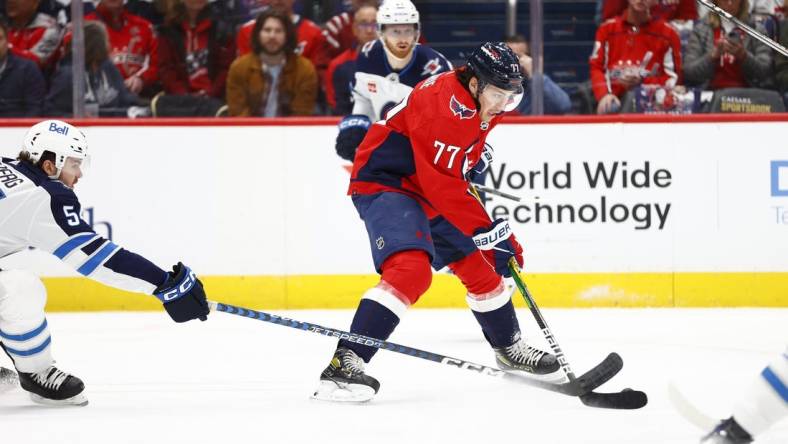 Mar 24, 2024; Washington, District of Columbia, USA; Washington Capitals right wing T.J. Oshie (77) controls the puck as Winnipeg Jets defenseman Dylan Samberg (54) defends during the first period at Capital One Arena. Mandatory Credit: Amber Searls-USA TODAY Sports