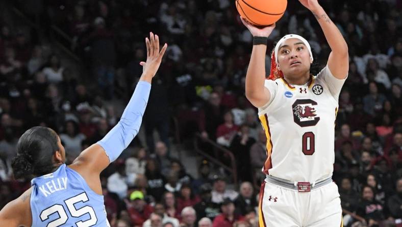 Mar 24, 2034; Columbia, So Carolina, USA;  South Carolina guard Te-Hina Paopao (0) makes a three-point shot near University of North Carolina guard Deja Kelly (25) during the second quarter of the second round NCAA Women's Basketball Tournament game at the Colonial Life Center.  Mandatory Credit: Ken Ruinard-USA TODAY Sports via Greenville News