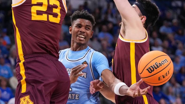 Indiana State Sycamores guard Julian Larry (1) passes the ball against Minnesota Golden Gophers forward Dawson Garcia (3) and Minnesota Golden Gophers forward Parker Fox (23) on Sunday, March 24, 2024, during the second round of the NIT at the Hulman Center in Terre Haute.