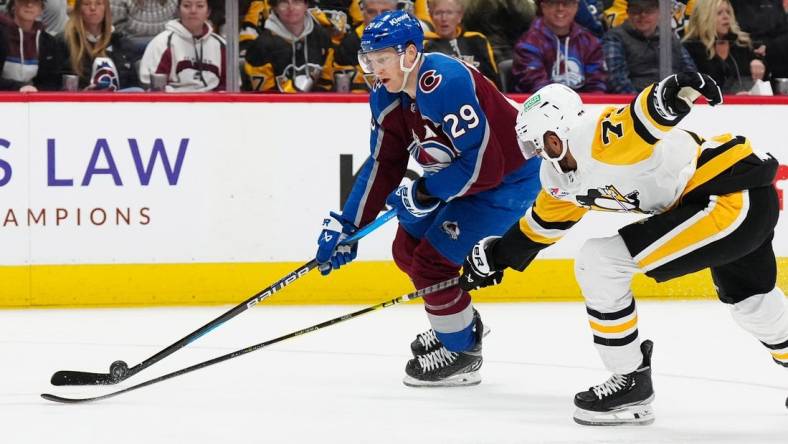 Mar 24, 2024; Denver, Colorado, USA; Pittsburgh Penguins defenseman Pierre-Olivier Joseph (73) defends on Colorado Avalanche center Nathan MacKinnon (29) in second period at Ball Arena. Mandatory Credit: Ron Chenoy-USA TODAY Sports