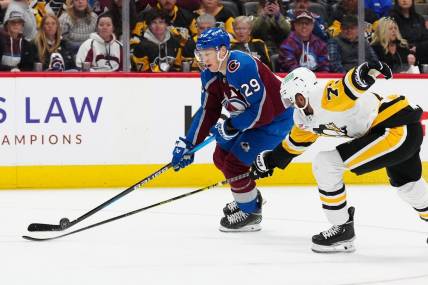 Mar 24, 2024; Denver, Colorado, USA; Pittsburgh Penguins defenseman Pierre-Olivier Joseph (73) defends on Colorado Avalanche center Nathan MacKinnon (29) in second period at Ball Arena. Mandatory Credit: Ron Chenoy-USA TODAY Sports