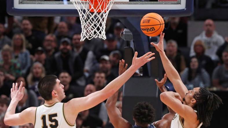 Purdue Boilermakers center Zach Edey (15), Utah State Aggies forward Nigel Burris (35) and Purdue Boilermakers forward Trey Kaufman-Renn (4) go for a rebound during NCAA Men’s Basketball Tournament game, Sunday, March 24, 2024, at Gainbridge Fieldhouse in Indianapolis.