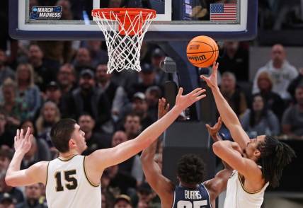 Purdue Boilermakers center Zach Edey (15), Utah State Aggies forward Nigel Burris (35) and Purdue Boilermakers forward Trey Kaufman-Renn (4) go for a rebound during NCAA Men’s Basketball Tournament game, Sunday, March 24, 2024, at Gainbridge Fieldhouse in Indianapolis.