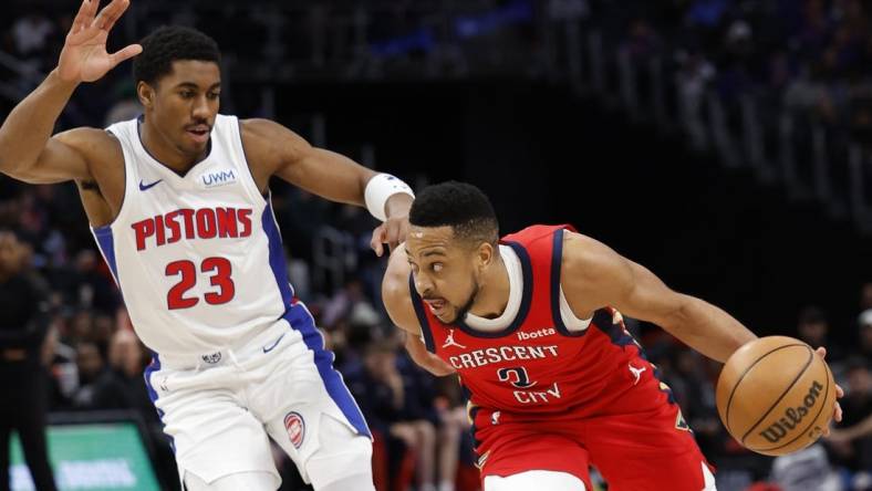 Mar 24, 2024; Detroit, Michigan, USA;  New Orleans Pelicans guard CJ McCollum (3) dribbles on Detroit Pistons guard Jaden Ivey (23) in the first half at Little Caesars Arena. Mandatory Credit: Rick Osentoski-USA TODAY Sports