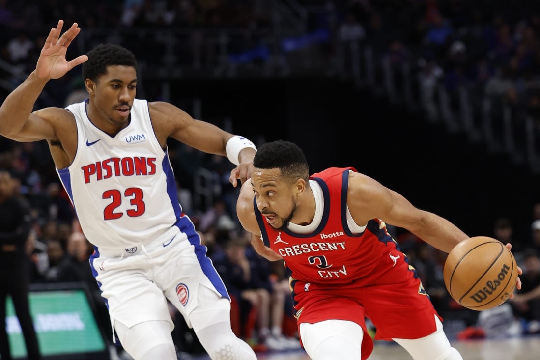 Mar 24, 2024; Detroit, Michigan, USA;  New Orleans Pelicans guard CJ McCollum (3) dribbles on Detroit Pistons guard Jaden Ivey (23) in the first half at Little Caesars Arena. Mandatory Credit: Rick Osentoski-USA TODAY Sports