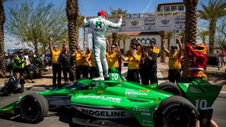 Alex Palou of Chip Ganassi Racing celebrates winning the feature race of the $1 Million Challenge with his team at The Thermal Club in Thermal, Calif., Sunday, March 24, 2024.