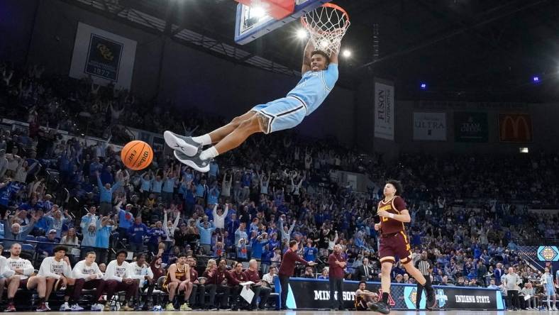 Indiana State Sycamores guard Julian Larry (1) dunks the ball Sunday, March 24, 2024, during the second round of the NIT at the Hulman Center in Terre Haute. The Indiana State Sycamores defeated the Minnesota Golden Gophers, 76-64.