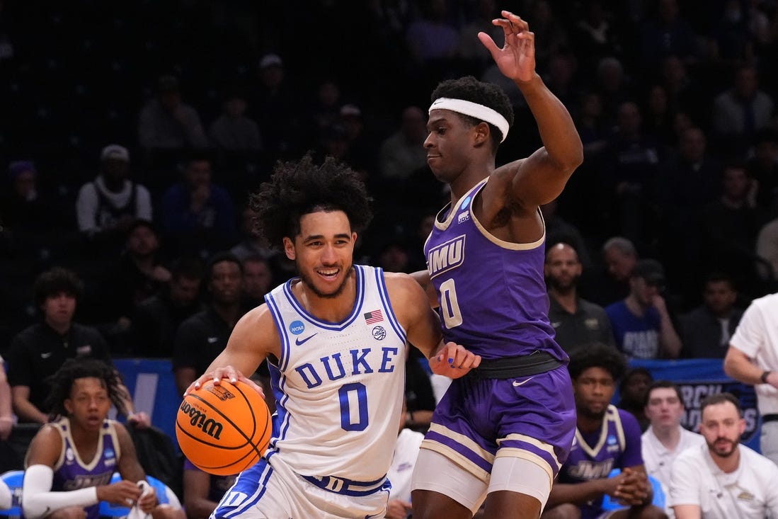 Mar 24, 2024; Brooklyn, NY, USA; Duke Blue Devils guard Jared McCain (0) dribbles the ball past James Madison Dukes guard Xavier Brown (0) in the second round of the 2024 NCAA Tournament  at Barclays Center. Mandatory Credit: Robert Deutsch-USA TODAY Sports