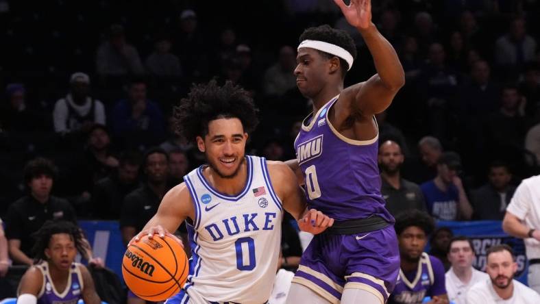 Mar 24, 2024; Brooklyn, NY, USA; Duke Blue Devils guard Jared McCain (0) dribbles the ball past James Madison Dukes guard Xavier Brown (0) in the second round of the 2024 NCAA Tournament  at Barclays Center. Mandatory Credit: Robert Deutsch-USA TODAY Sports