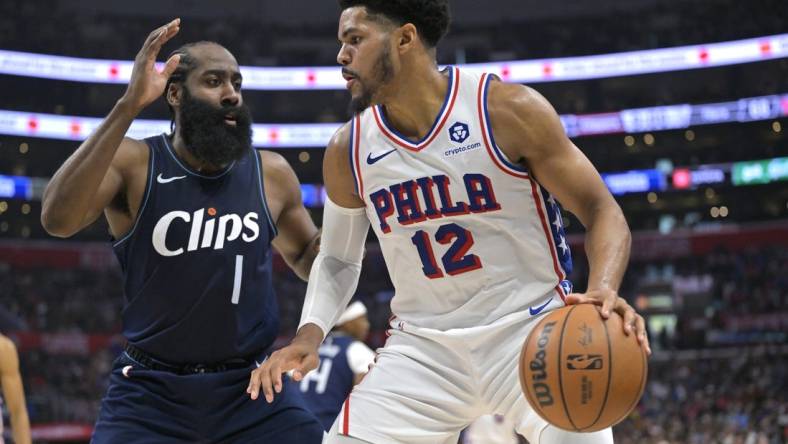 Mar 24, 2024; Los Angeles, California, USA;   Philadelphia 76ers forward Tobias Harris (12) is defended by Los Angeles Clippers guard James Harden (1) in the second half at Crypto.com Arena. Mandatory Credit: Jayne Kamin-Oncea-USA TODAY Sports