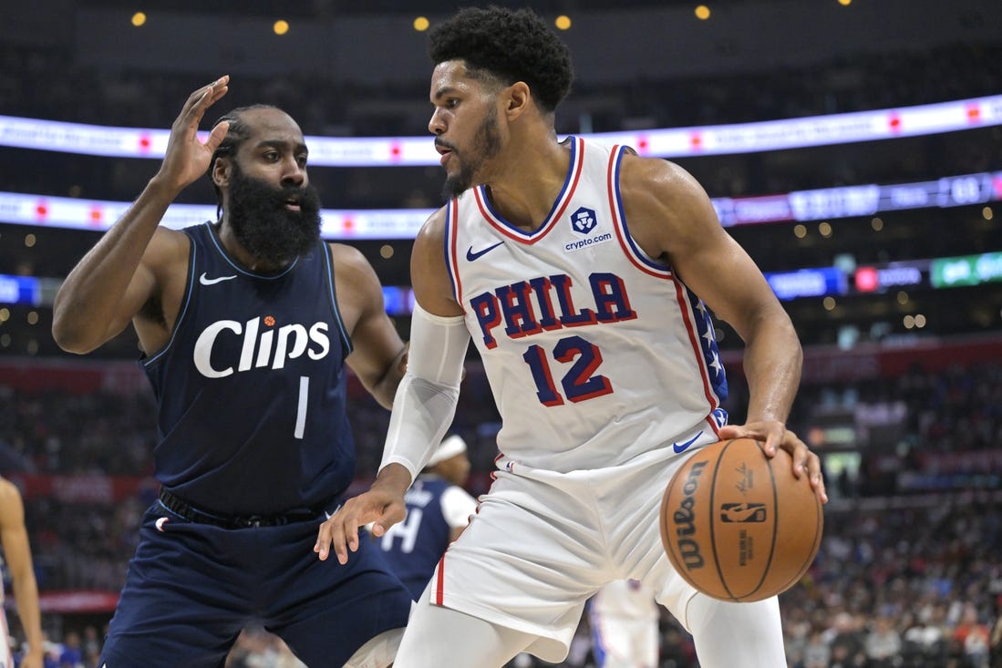 Mar 24, 2024; Los Angeles, California, USA;   Philadelphia 76ers forward Tobias Harris (12) is defended by Los Angeles Clippers guard James Harden (1) in the second half at Crypto.com Arena. Mandatory Credit: Jayne Kamin-Oncea-USA TODAY Sports