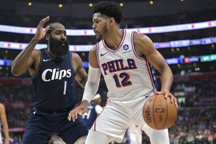 Mar 24, 2024; Los Angeles, California, USA;   Philadelphia 76ers forward Tobias Harris (12) is defended by Los Angeles Clippers guard James Harden (1) in the second half at Crypto.com Arena. Mandatory Credit: Jayne Kamin-Oncea-USA TODAY Sports