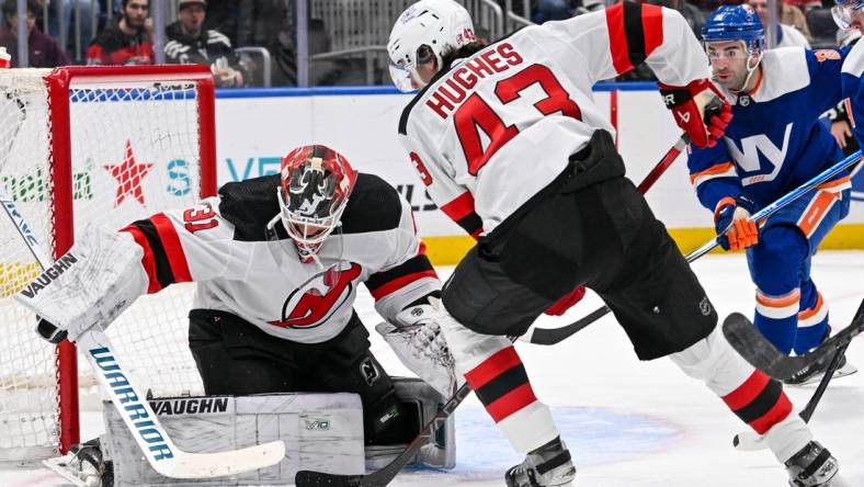 Mar 24, 2024; Elmont, New York, USA;  New Jersey Devils goaltender Kaapo Kahkonen (31) makes a save against the New York Islanders during the second period at UBS Arena. Mandatory Credit: Dennis Schneidler-USA TODAY Sports