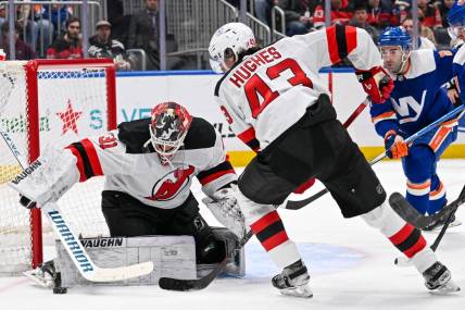 Mar 24, 2024; Elmont, New York, USA;  New Jersey Devils goaltender Kaapo Kahkonen (31) makes a save against the New York Islanders during the second period at UBS Arena. Mandatory Credit: Dennis Schneidler-USA TODAY Sports