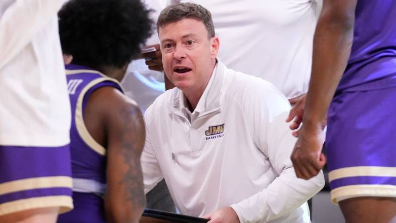 Mar 24, 2024; Brooklyn, NY, USA; James Madison Dukes head coach Mark Byington talks to the team during a time out against the Duke Blue Devils in the second round of the 2024 NCAA Tournament  at Barclays Center. Mandatory Credit: Robert Deutsch-USA TODAY Sports