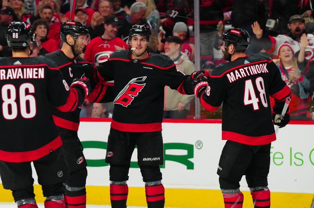 Mar 24, 2024; Raleigh, North Carolina, USA;  Carolina Hurricanes defenseman Brady Skjei (76) celebrates his goal with left wing Jordan Martinook (48) and center Jordan Staal (11) against the Toronto Maple Leafs during the first period at PNC Arena. Mandatory Credit: James Guillory-USA TODAY Sports