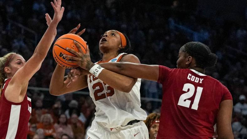 Texas forward Aaliyah Moore (23) is fouled by Alabama forward Essence Cody (21).