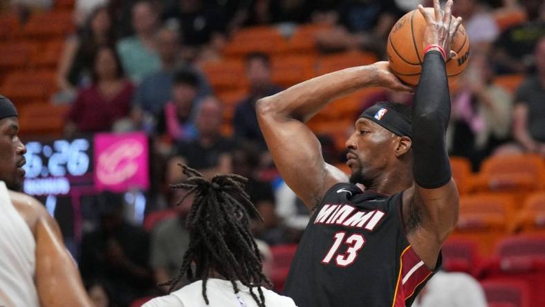 Mar 24, 2024; Miami, Florida, USA;  Miami Heat center Bam Adebayo (13) looks to pass the ball against the Cleveland Cavaliers defense during the first half at Kaseya Center. Mandatory Credit: Jim Rassol-USA TODAY Sports