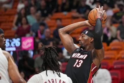 Mar 24, 2024; Miami, Florida, USA;  Miami Heat center Bam Adebayo (13) looks to pass the ball against the Cleveland Cavaliers defense during the first half at Kaseya Center. Mandatory Credit: Jim Rassol-USA TODAY Sports