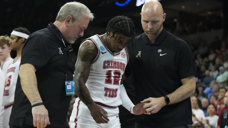 Mar 24, 2024; Spokane, WA, USA; Alabama Crimson Tide guard Latrell Wrightsell Jr. (12) is attended to by official in the first half against the Grand Canyon Antelopes at Spokane Veterans Memorial Arena. Mandatory Credit: Kirby Lee-USA TODAY Sports