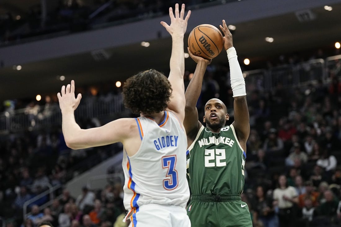 Mar 24, 2024; Milwaukee, Wisconsin, USA;  Milwaukee Bucks forward Khris Middleton (22) shoots against Oklahoma City Thunder guard Josh Giddey (3) during the third quarter at Fiserv Forum. Mandatory Credit: Jeff Hanisch-USA TODAY Sports