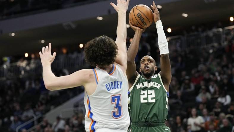 Mar 24, 2024; Milwaukee, Wisconsin, USA;  Milwaukee Bucks forward Khris Middleton (22) shoots against Oklahoma City Thunder guard Josh Giddey (3) during the third quarter at Fiserv Forum. Mandatory Credit: Jeff Hanisch-USA TODAY Sports