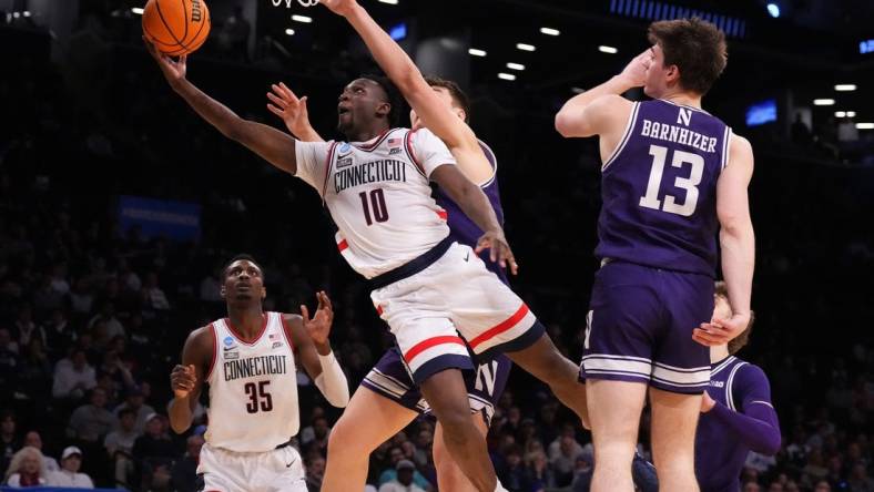 Mar 24, 2024; Brooklyn, NY, USA; Connecticut Huskies guard Hassan Diarra (10) shoots the ball against the Northwestern Wildcats in the second round of the 2024 NCAA Tournament at the Barclays Center. Mandatory Credit: Robert Deutsch-USA TODAY Sports