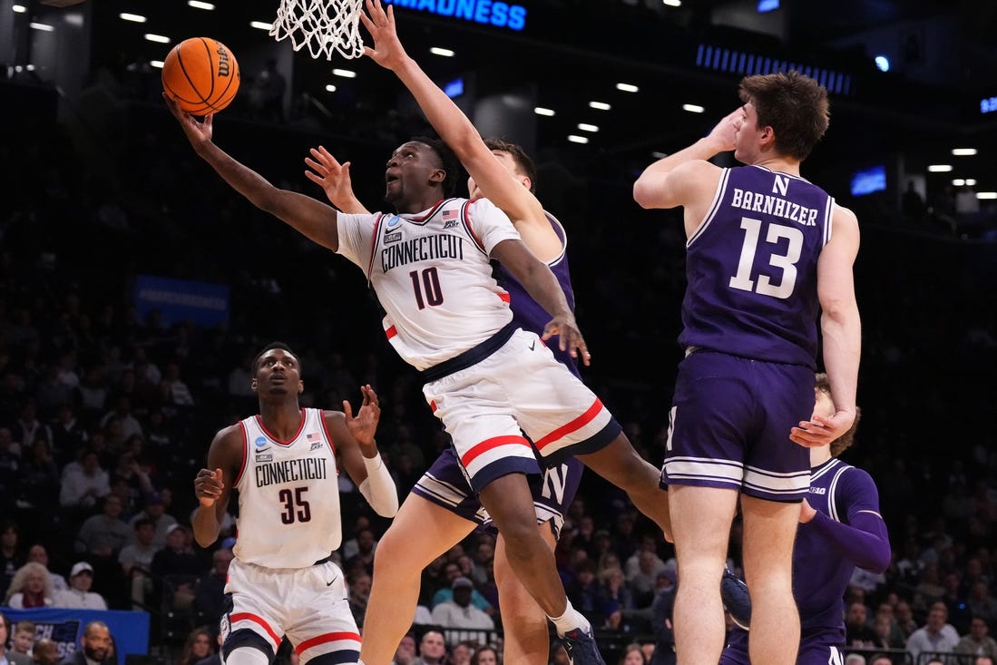 Mar 24, 2024; Brooklyn, NY, USA; Connecticut Huskies guard Hassan Diarra (10) shoots the ball against the Northwestern Wildcats in the second round of the 2024 NCAA Tournament at the Barclays Center. Mandatory Credit: Robert Deutsch-USA TODAY Sports