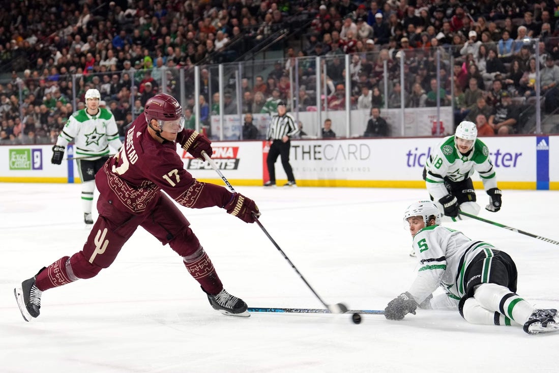 Mar 24, 2024; Tempe, Arizona, USA; Arizona Coyotes center Nick Bjugstad (17) shoots the puck by Dallas Stars defenseman Nils Lundkvist (5) during the second period at Mullett Arena. Mandatory Credit: Joe Camporeale-USA TODAY Sports