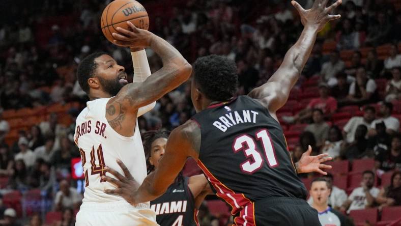 Mar 24, 2024; Miami, Florida, USA;  Cleveland Cavaliers forward Marcus Morris Sr. (24) takes a shot over Miami Heat center Thomas Bryant (31) during the second half at Kaseya Center. Mandatory Credit: Jim Rassol-USA TODAY Sports