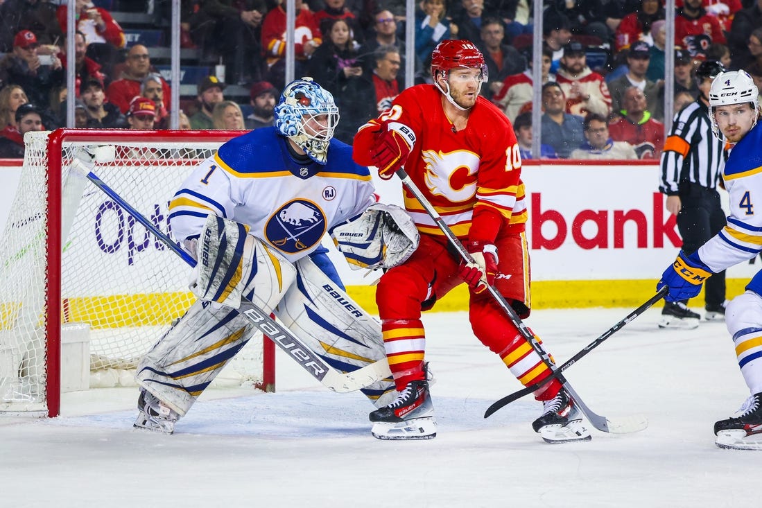 Mar 24, 2024; Calgary, Alberta, CAN; Calgary Flames center Jonathan Huberdeau (10) screens in front of Buffalo Sabres goaltender Ukko-Pekka Luukkonen (1) during the second period at Scotiabank Saddledome. Mandatory Credit: Sergei Belski-USA TODAY Sports