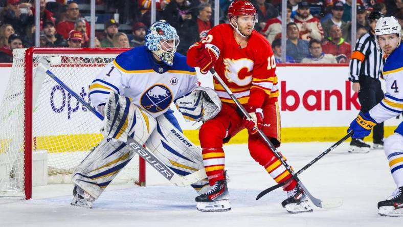 Mar 24, 2024; Calgary, Alberta, CAN; Calgary Flames center Jonathan Huberdeau (10) screens in front of Buffalo Sabres goaltender Ukko-Pekka Luukkonen (1) during the second period at Scotiabank Saddledome. Mandatory Credit: Sergei Belski-USA TODAY Sports