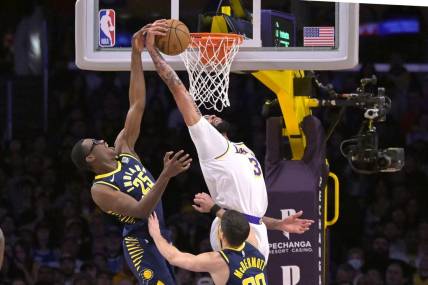 Mar 24, 2024; Los Angeles, California, USA;   Los Angeles Lakers forward Anthony Davis (3) grabs his own rebound and scores past Indiana Pacers forward Jalen Smith (25) in the first half at Crypto.com Arena. Mandatory Credit: Jayne Kamin-Oncea-USA TODAY Sports
