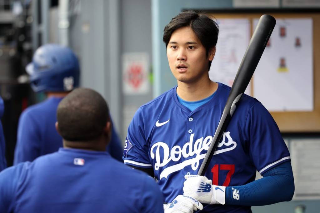 Mar 24, 2024; Los Angeles, California, USA;  Los Angeles Dodgers designated hitter Shohei Ohtani (17) holds a bat in the dugout prior to the game against the Los Angeles Angels at Dodger Stadium. Mandatory Credit: Kiyoshi Mio-USA TODAY Sports
