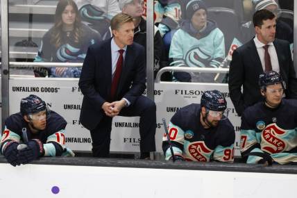 Mar 24, 2024; Seattle, Washington, USA; Seattle Kraken head coach Dave Hakstol, back left, stands behind the bench as center Jaden Schwartz (17) and left wing Tomas Tatar (90) watch the final seconds of the third period against the Montreal Canadiens at Climate Pledge Arena. Mandatory Credit: Joe Nicholson-USA TODAY Sports