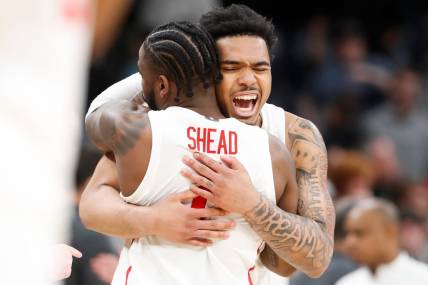 Houston's Jamal Shead (1) and Ramon Walker Jr. (3) celebrate after Houston defeated Texas A&M 100-95 in overtime in the second round of the 2024 NCAA Tournament at FedExForum in Memphis, Tenn., on Sunday, March 24, 2024.
