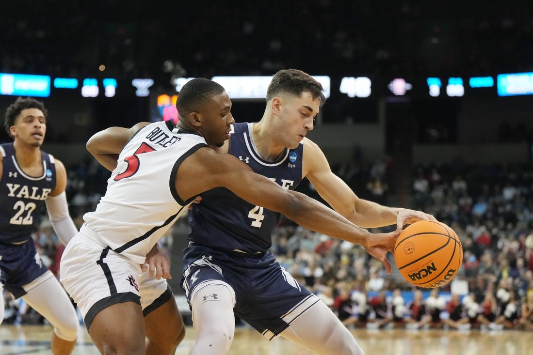 Mar 24, 2024; Spokane, WA, USA; Yale Bulldogs guard John Poulakidas (4) battles San Diego State Aztecs guard Lamont Butler (5) for the ball in the second half at Spokane Veterans Memorial Arena. Mandatory Credit: Kirby Lee-USA TODAY Sports