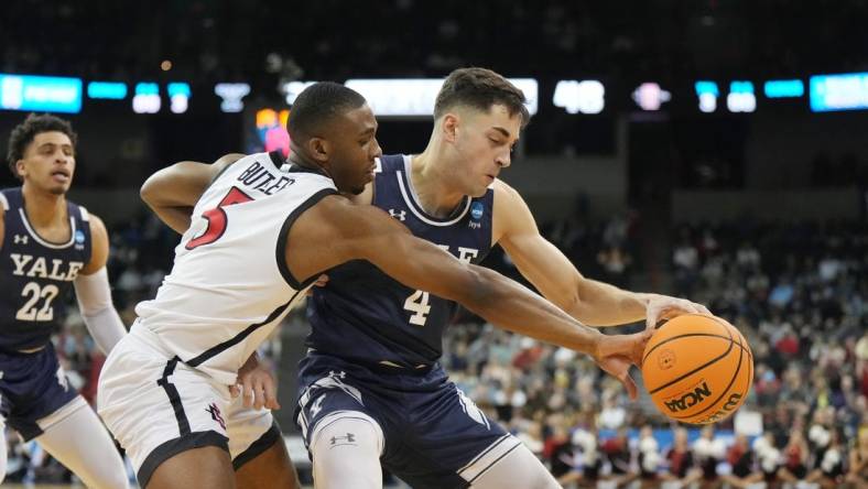 Mar 24, 2024; Spokane, WA, USA; Yale Bulldogs guard John Poulakidas (4) battles San Diego State Aztecs guard Lamont Butler (5) for the ball in the second half at Spokane Veterans Memorial Arena. Mandatory Credit: Kirby Lee-USA TODAY Sports