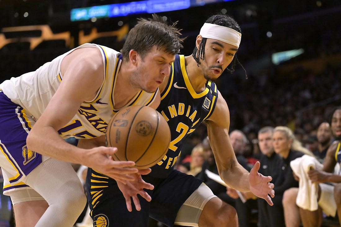 Mar 24, 2024; Los Angeles, California, USA;   Los Angeles Lakers guard Austin Reaves (15) and Indiana Pacers guard Andrew Nembhard (2) go for the ball in the second half at Crypto.com Arena. Mandatory Credit: Jayne Kamin-Oncea-USA TODAY Sports