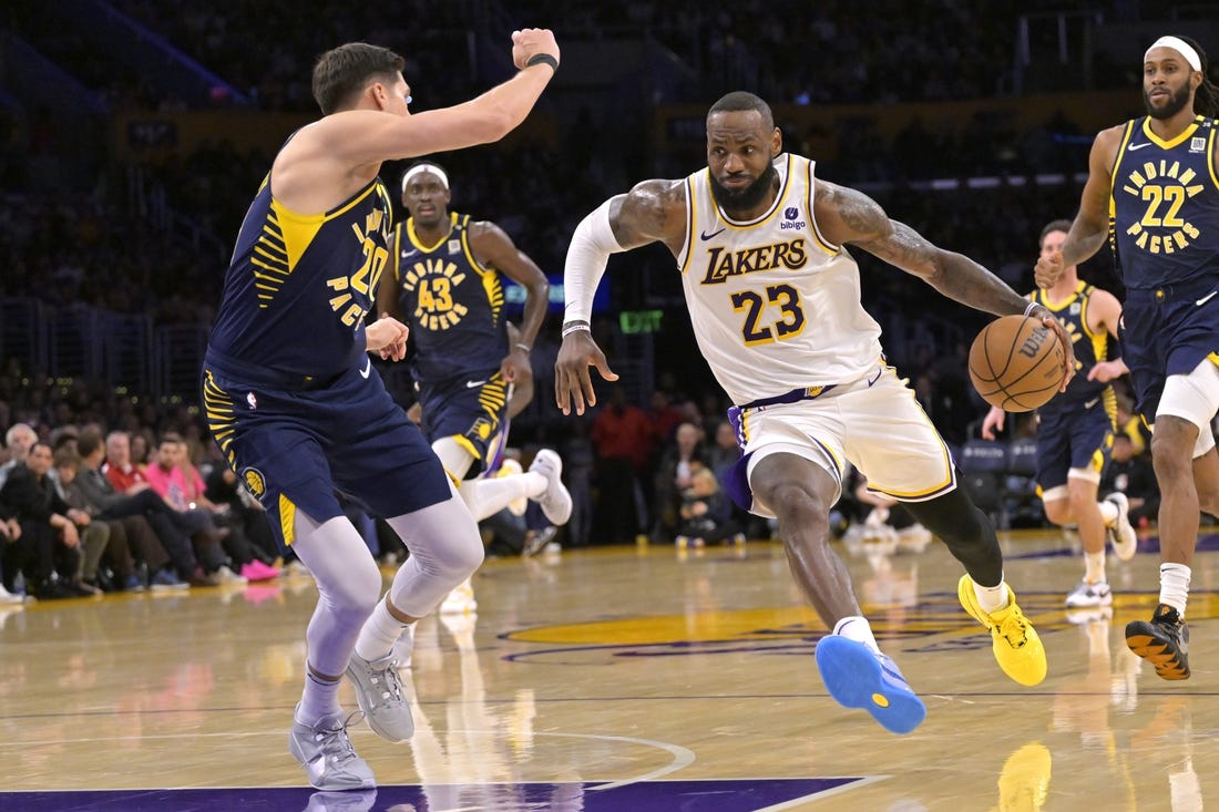 Mar 24, 2024; Los Angeles, California, USA;   Los Angeles Lakers forward LeBron James (23) drives past Indiana Pacers forward Doug McDermott (20) in the second half at Crypto.com Arena. Mandatory Credit: Jayne Kamin-Oncea-USA TODAY Sports