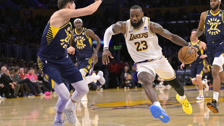 Mar 24, 2024; Los Angeles, California, USA;   Los Angeles Lakers forward LeBron James (23) drives past Indiana Pacers forward Doug McDermott (20) in the second half at Crypto.com Arena. Mandatory Credit: Jayne Kamin-Oncea-USA TODAY Sports