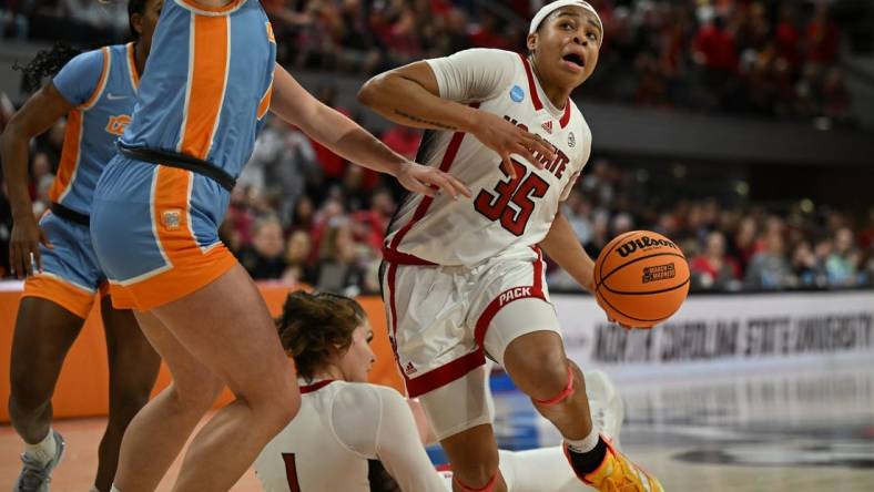 Mar 25, 2024; Raleigh, North Carolina, USA; NC State Wolfpack guard Zoe Brooks (35) drives past Tennessee Lady Vols guard Sara Puckett (1) in the second round of the 2024 NCAA Women's Tournament at James T. Valvano Arena at William Neal Reynolds. Mandatory Credit: William Howard-USA TODAY Sports