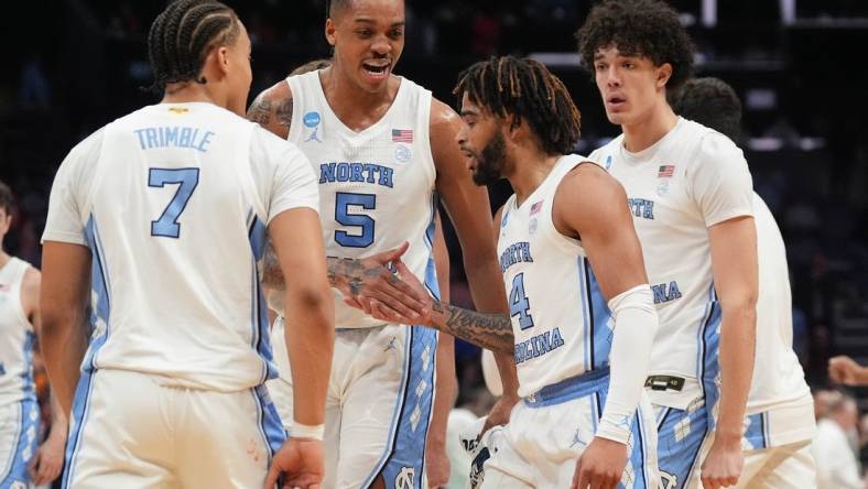 Mar 23, 2024; Charlotte, NC, USA;  North Carolina Tar Heels forward Armando Bacot (5) congratulates guard RJ Davis (4) after hitting a three point shot against Michigan State Spartans at Spectrum Center. Mandatory Credit: Jim Dedmon-USA TODAY Sports