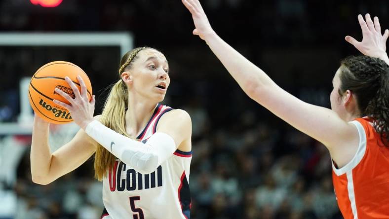 Mar 25, 2024; Storrs, Connecticut, USA; UConn Huskies guard Paige Bueckers (5) looks for an opening against the Syracuse Orange in the first half at Harry A. Gampel Pavilion. Mandatory Credit: David Butler II-USA TODAY Sports