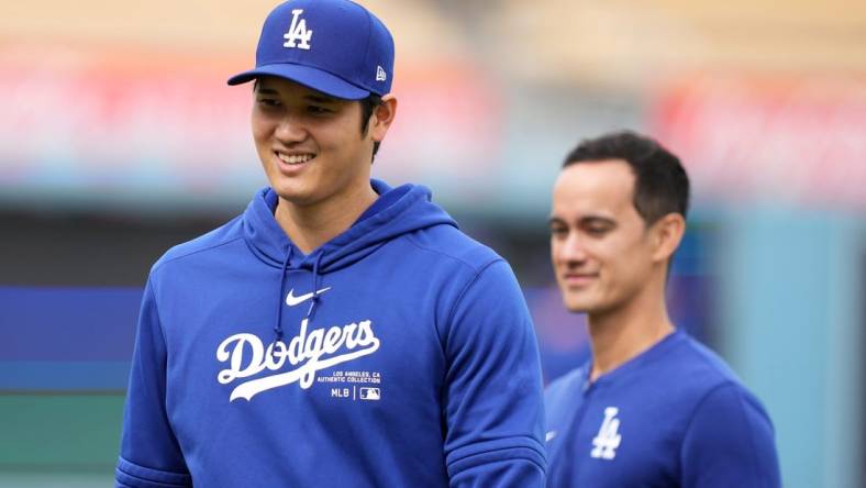 Mar 25, 2024; Los Angeles, California, USA; Los Angeles Dodgers designated hitter Shohei Ohtani (left) and interpreter Will Ireton before the game against the Los Angeles Angels at Dodger Stadium. Mandatory Credit: Kirby Lee-USA TODAY Sports