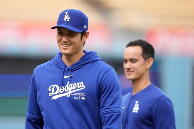 Mar 25, 2024; Los Angeles, California, USA; Los Angeles Dodgers designated hitter Shohei Ohtani (left) and interpreter Will Ireton before the game against the Los Angeles Angels at Dodger Stadium. Mandatory Credit: Kirby Lee-USA TODAY Sports